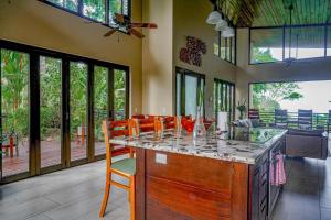 a kitchen with a island with a counter in a room at Casa Vista Verde in Uvita