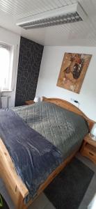 a bedroom with a wooden bed in a room at Bacchus in Hatzenport