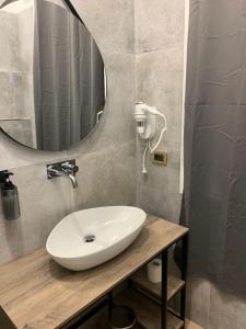 a bathroom with a white sink and a mirror at Riva Reno 4 Rooms in Bologna