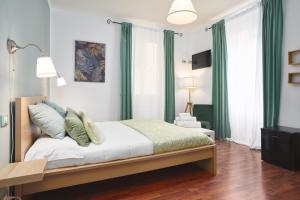 a bedroom with a large bed with green curtains at Hotiday La Spezia Quiet Night in La Spezia