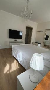 a bedroom with a bed with a television and a lamp at Sottocastello 1 in Gorizia