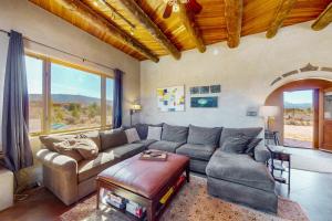 a living room with a couch and a table at Pow Days Taos in Taos