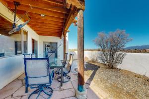 a porch with chairs and a table on a house at Pow Days Taos in Taos