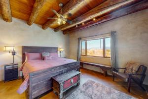 a bedroom with a large bed and a window at Pow Days Taos in Taos