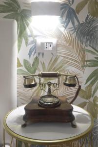an old fashioned phone sitting on a table in a room at Residenza al Colosseo in Rome