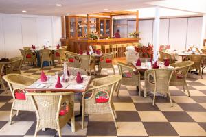 a restaurant with tables and chairs with pink napkins on them at Bird Of Paradise Hotel in Goroka