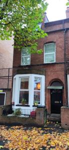 a brick house with a white front door at CASTLETON in Belfast