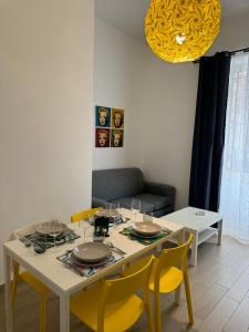 tavolo da pranzo con sedie gialle e luce gialla di Villafranca settantuno Apartments a Palermo