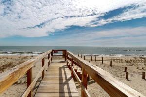a wooden pathway to the beach with the ocean at Sea Forever in Kure Beach +42 photos