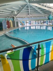a large swimming pool in a large building at Serenity Coast in Wyke Regis