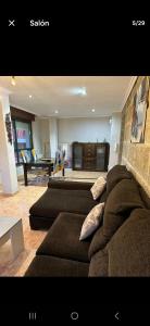a living room with a couch and a table at Precioso chalet cerca de la playa de Samil in Vigo