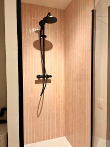 een douche met een douchekop in een badkamer bij Portofino - luxe appartement met lateraal zeezicht in Oostende