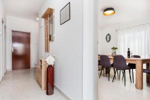 a dining room and kitchen with a table and chairs at Apartment Ivo in Rovinj
