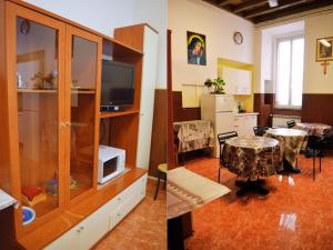 a living room with a tv and a dining room at Ostello Marello in Rome