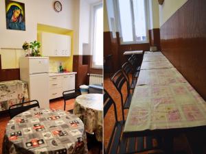 a room with a long table with chairs and a kitchen at Ostello Marello in Rome