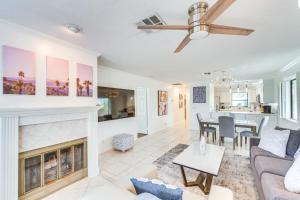 a living room with a fireplace and a dining room at Home with Pool Access in Palm Desert Near Golf! in Palm Desert