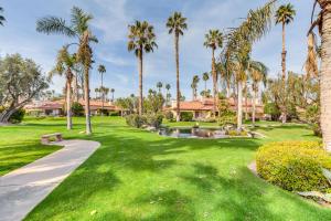 a park with palm trees and a pathway at Palm Desert Home with Pool Access - Near Golfing! in Palm Desert