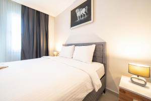 a bedroom with a white bed and a window at Dedeminn Garden Hotel in Göcek