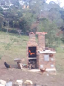 a brick oven with a fire in it in a field at glamping volvere san GabrieL 
