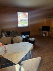 a living room with a table and a couch at Nimród apartman in Gabčíkovo