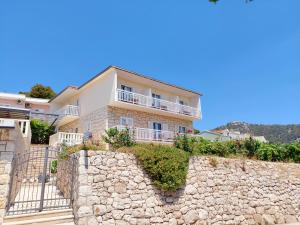 a house on top of a stone wall at Vila Luka 2 in Hvar