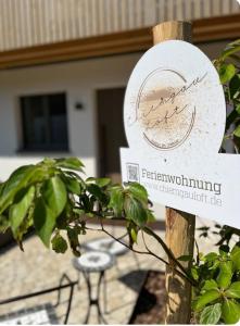 a sign for a fethium monitoringowment sig at Chiemgauloft am Chiemsee in Übersee