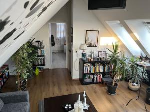 a living room with potted plants and a staircase at Im Herzen von Esens , nah an der Küste in Esens