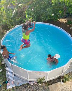 a group of people playing in a swimming pool at RefleXion Views in Belle Garden