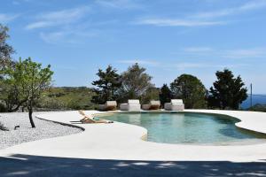 a swimming pool in the middle of a yard at Villa Alexandra in Patmos