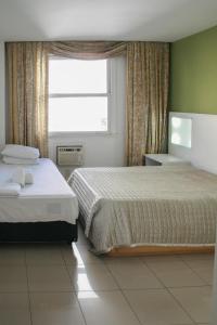Giường trong phòng chung tại 3 suítes Copacabana vista mar