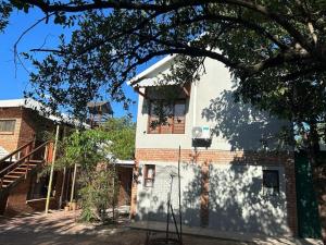 a building with a basketball hoop in front of it at Tree Symphony in Marloth Park