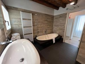 La salle de bains est pourvue d'une baignoire, d'un lavabo et d'une baignoire. dans l'établissement Ca' Del Vecio, in centro storico, Piazza Garibaldi, à Bassano del Grappa