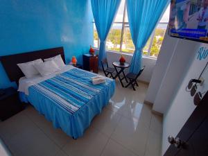 En eller flere senge i et værelse på RIO DULCE HOTELES - TARAPOTO