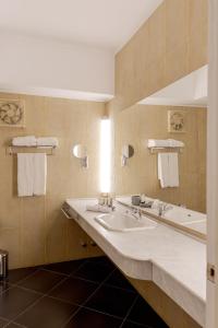 a bathroom with two sinks and a large mirror at La Siesta Hotel Al Sokhna in Ain Sokhna