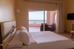 a bedroom with a bed with a view of the ocean at La Siesta Hotel Al Sokhna in Ain Sokhna +44 photos