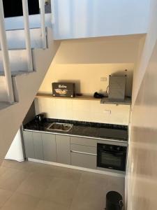 a small kitchen with a sink and a counter top at Duplex Cerró Victoria in Potrero de los Funes