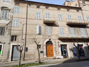 an old brick building with a wooden door at Palazzo Trevisani in Porto San Giorgio