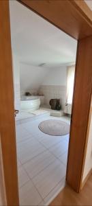 an open door to a bathroom with a tub at Stilvolle Ferienwohnung in Niestetal