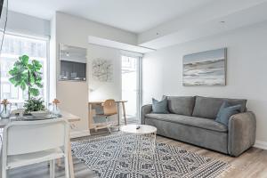 a living room with a couch and a table at Toronto Garden Apartments in Toronto