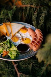 a plate of eggs and bacon and vegetables on a table at Spa-hotel Dobrynia in Odesa