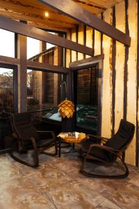 a patio with two chairs and a table and a fireplace at Spa-hotel Dobrynia in Odesa