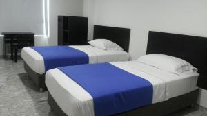 Hotel Bucare客房内的一张或多张床位