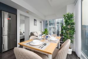 a dining room with a table and chairs and a kitchen at Toronto Garden Apartments in Toronto