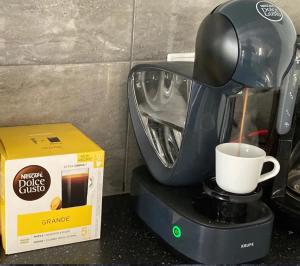 a coffee maker and a box on a counter at Domek A 134 Makowe Marzenie- Kaszubska Ostoja in Barkocin +3 photos