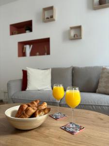 a table with a bowl of bread and two glasses of orange juice at Le Duplex Safari in Saint-Aignan +15 photos