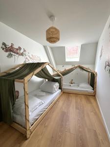 a bedroom with two bunk beds in a attic at Le Duplex Safari in Saint-Aignan