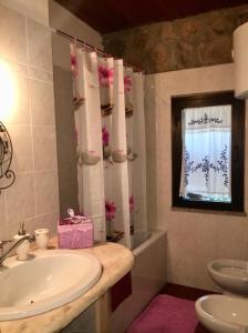 a bathroom with a sink and a toilet and a window at Cala Ginepro Tortoli in Bari Sardo