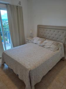 a bedroom with a bed and a window with a view at Departamento Alero in Goya +13 photos