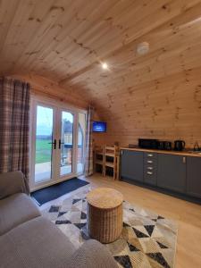 a living room with a couch and a table at Lois' Pod with Hot Tub, Near Airport in Bristol