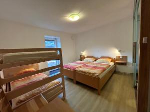 a bedroom with two bunk beds in a room at Apartments Mrakič in Bovec